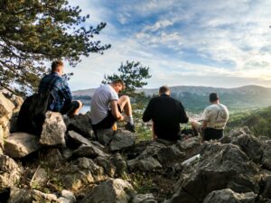 Group of men sitting outside